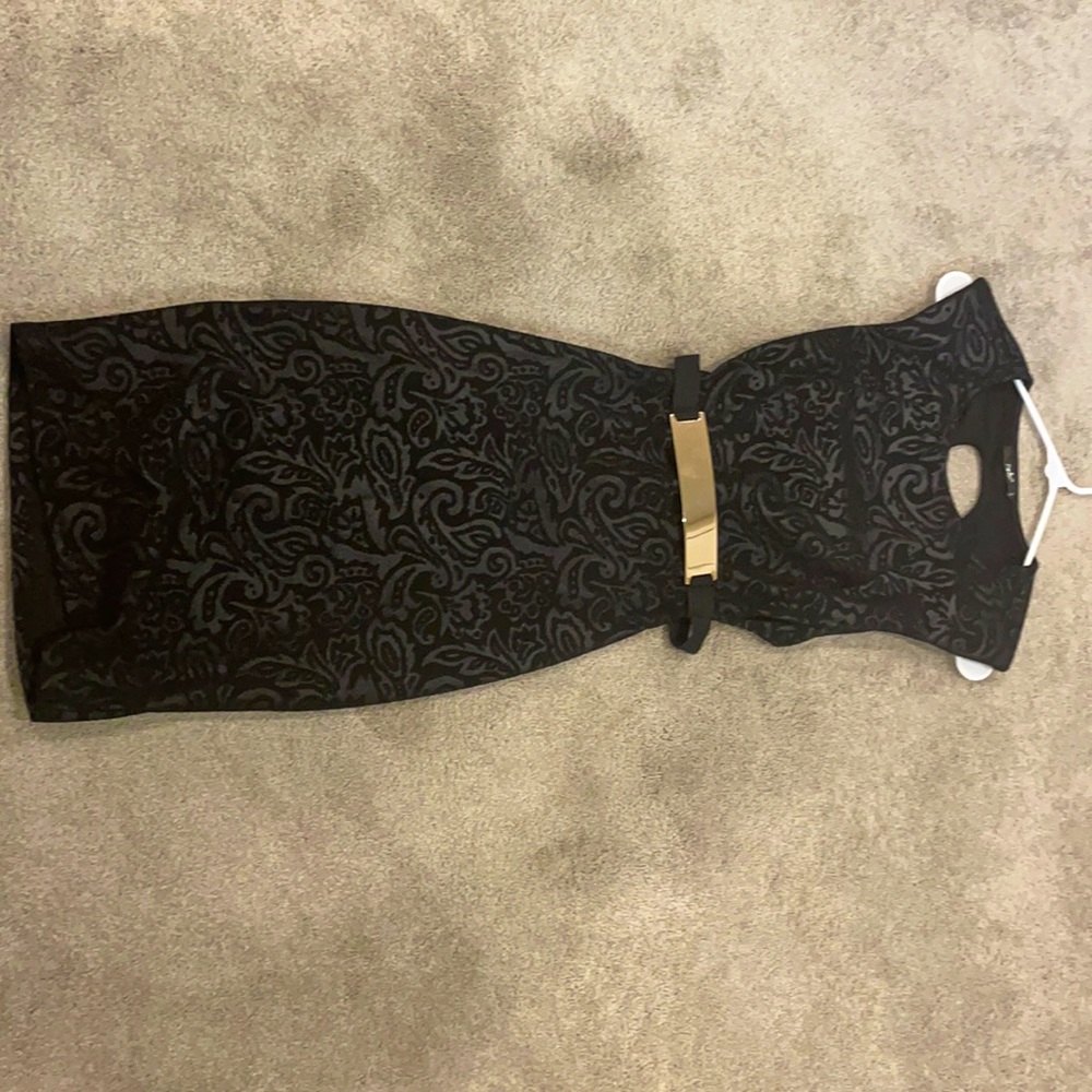 Black printed dress with gold belt and open back.